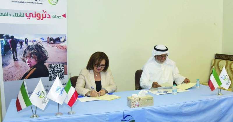 جمال النوري ونسرين ربيعان خلال توقيع الاتفاقية