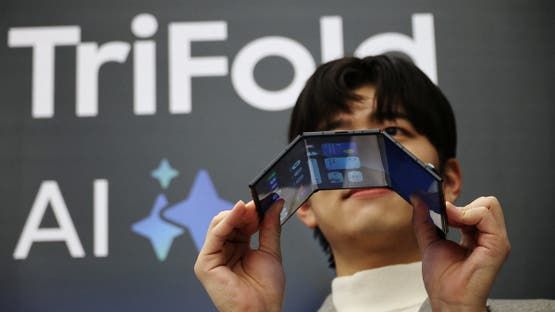 A model poses for photographs with a Galaxy Z TriFold during an event at its store in Seoul, South Korea, December 2, 2025. REUTERS/Kim Hong-Ji